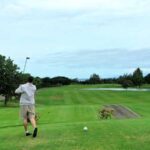 Stunning view of Hawaii Kai Golf Course surrounded by mountains and ocean.