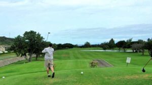 Stunning view of Hawaii Kai Golf Course surrounded by mountains and ocean.