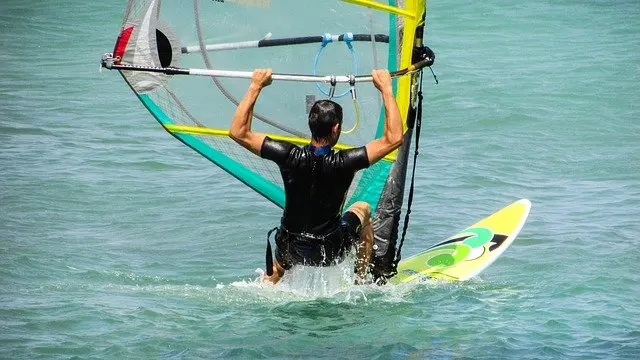 Windsurfing in Hawaii with clear blue waters and a bright sunny sky